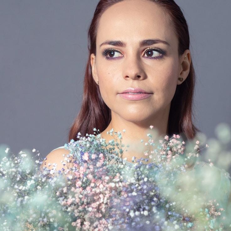 Avery Chen, Lead Design Curator at Clean Parcel Studio, reviewing corporate floral arrangements